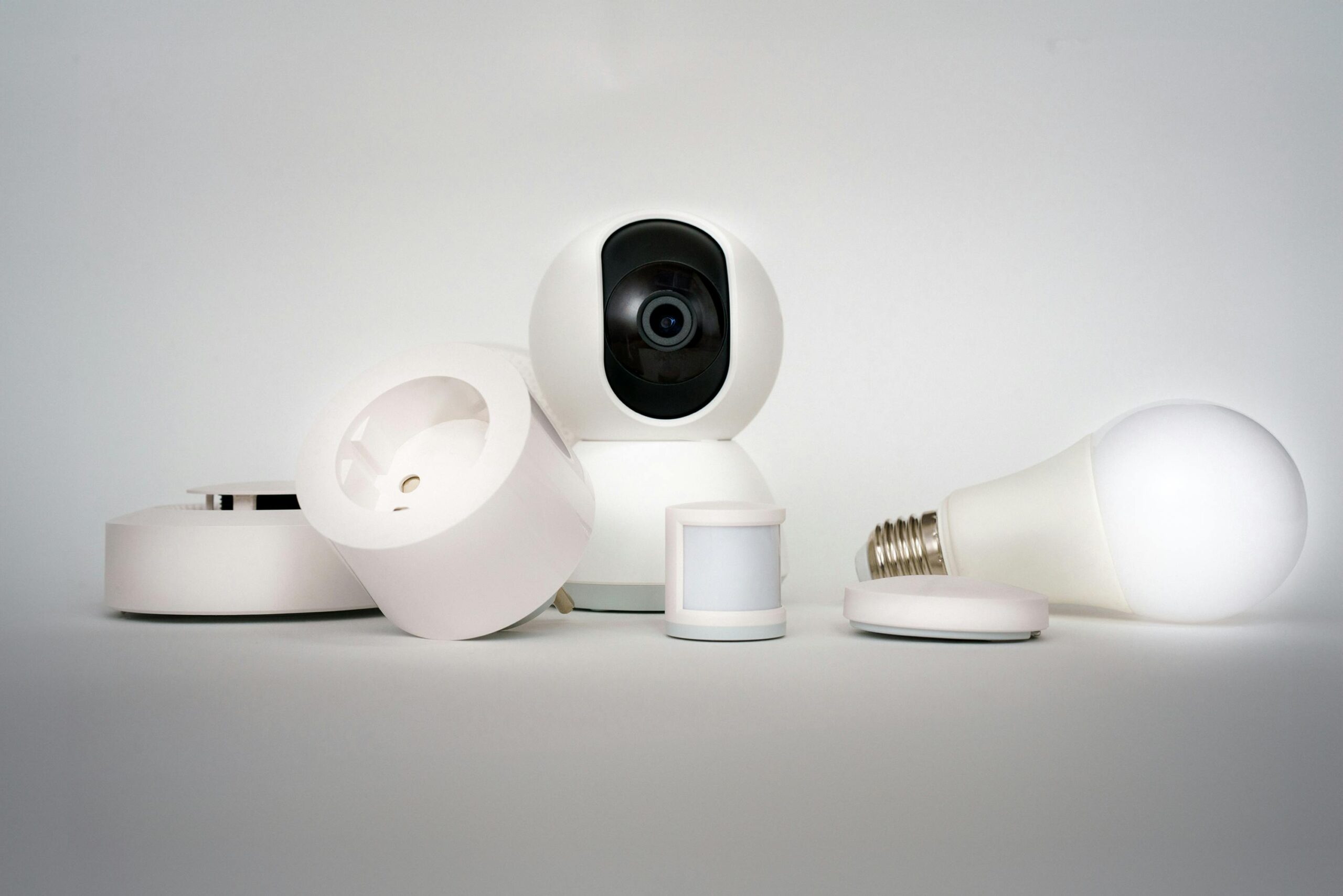Home A range of smart home devices including camera and lightbulb in a minimalist setup.